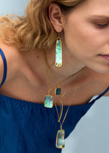 model wearing 18kt gold beachcomber earrings & necklaces